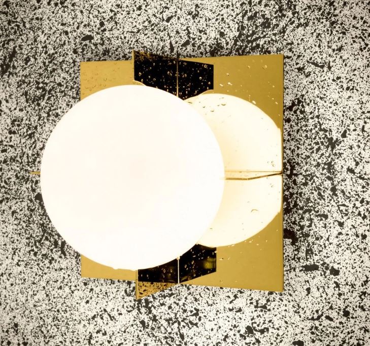 Designer bathroom light with globe shade and square gold brass back plate