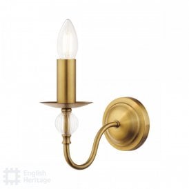 candle style wall light in aged brass threaded with ribbed glass bead